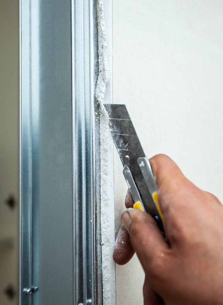 Worker building plasterboard wall.